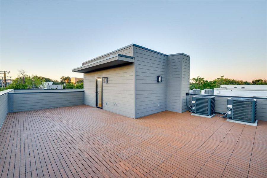 Patio terrace at dusk featuring central AC