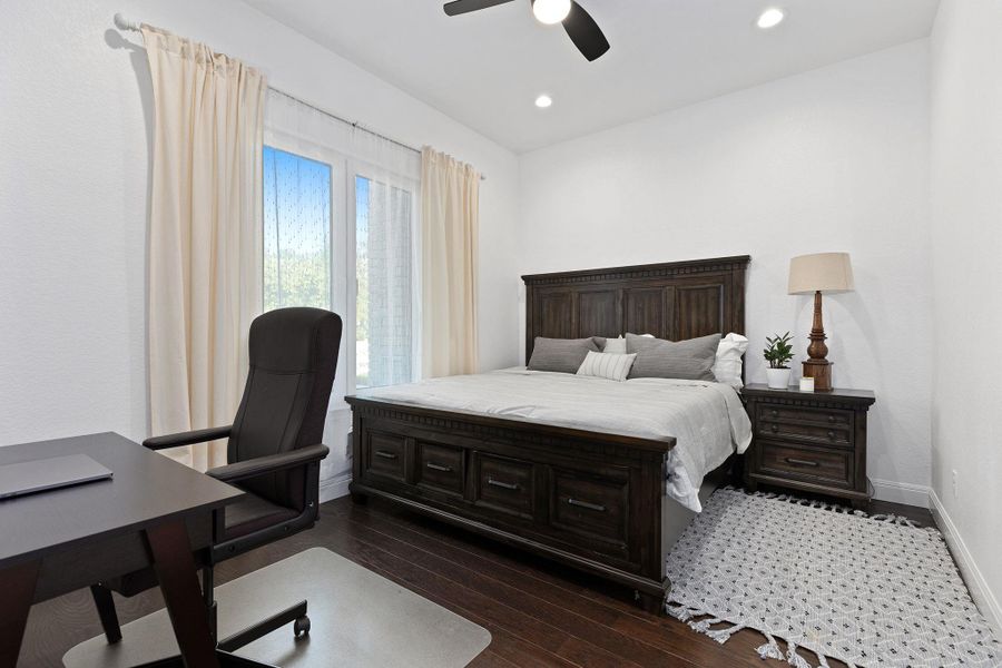 Bedroom featuring dark wood-style flooring, recessed lighting, and a ceiling fan Bedroom featuring dark wood-style flooring, recessed lighting, and a ceiling fan