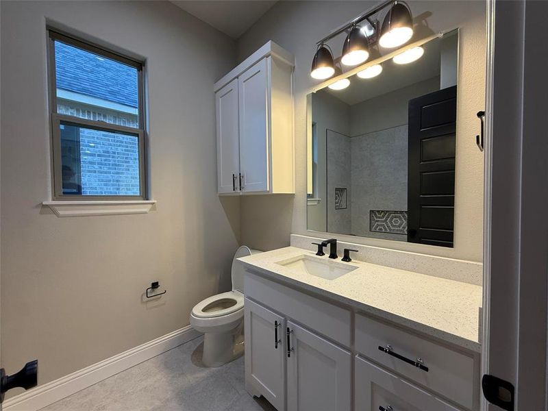 Bathroom featuring vanity and light tile patterned floors Bathroom featuring vanity and light tile patterned floors