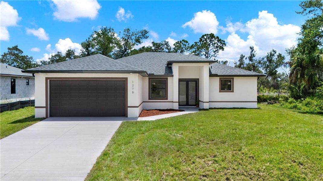 Front exterior of a new home in , Port Charlotte, FL, highlighting curb appeal (Image 25).