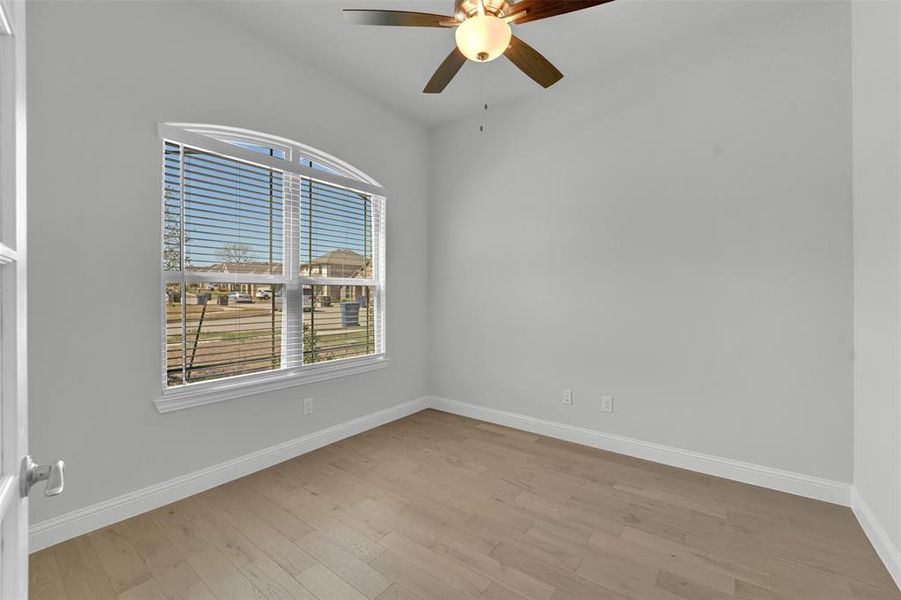 Spare room with light wood-style floors and ceiling fan