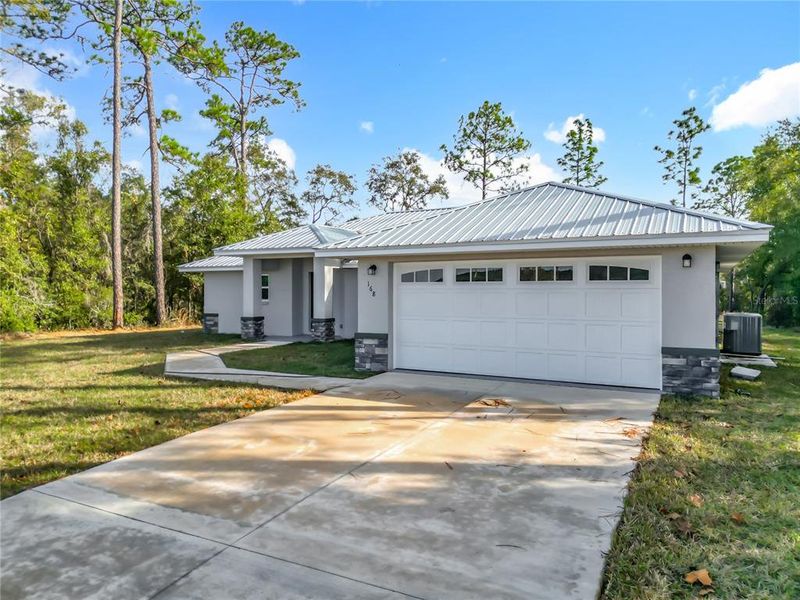 Front exterior of a new home in , Citrus Springs, FL, highlighting curb appeal (Image 1). Front exterior of a new home in , Citrus Springs, FL, highlighting curb appeal (Image 1).