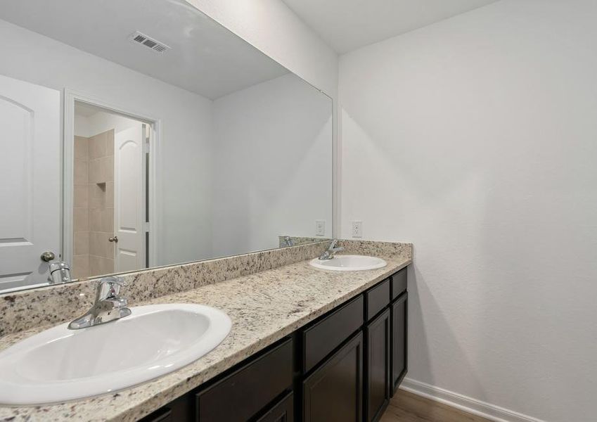 Guest bathroom with a double-sink vanity and a private restroom.