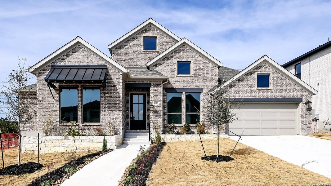 Front exterior of a new home in Kinder Ranch, San Antonio, TX, highlighting curb appeal (Image 21).