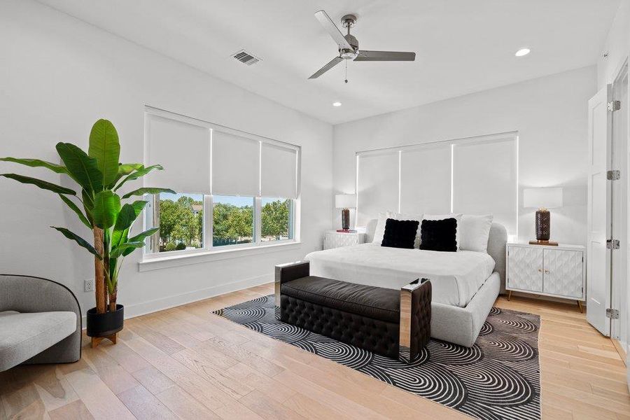 Hardwood floors and generous windows create an airy, naturally illuminated bedroom. Hardwood floors and generous windows create an airy, naturally illuminated bedroom.