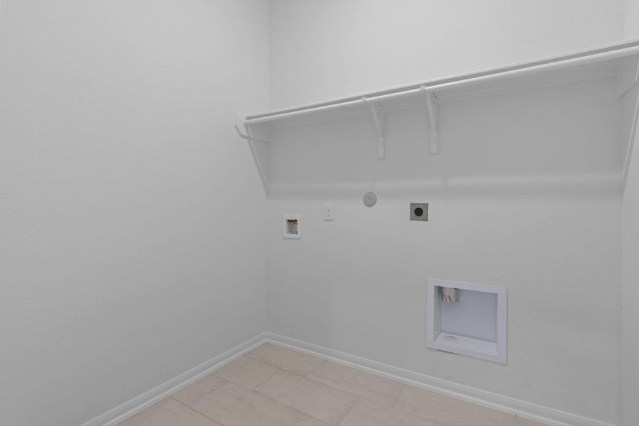 The laundry room layout is carefully planned for optimal workflow with designated areas for washing, drying, and storing. The laundry room layout is carefully planned for optimal workflow with designated areas for washing, drying, and storing.