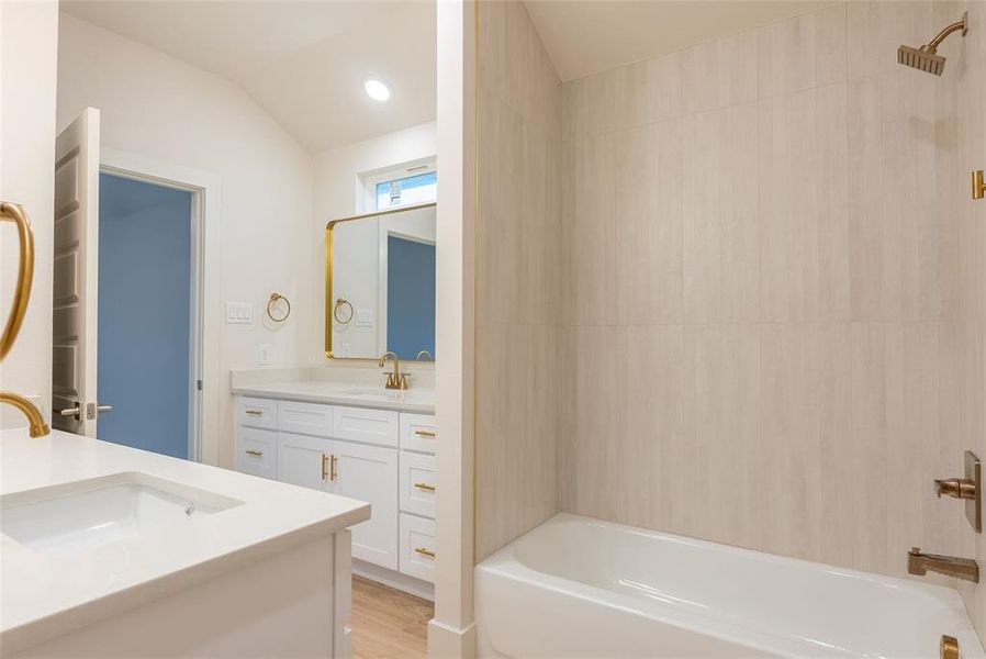Full bath with shower / bath combination, vanity, recessed lighting, and light wood finished floors