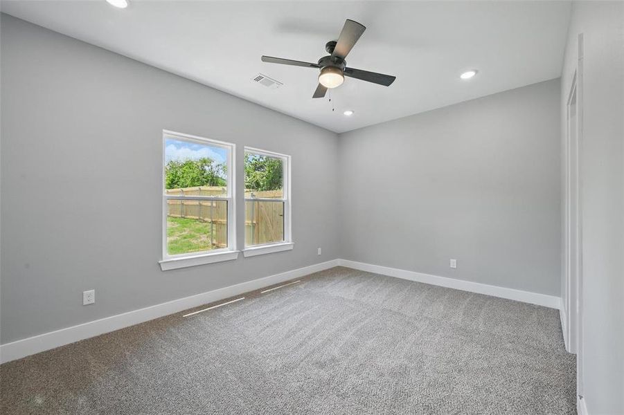 Unfurnished room featuring carpet flooring, a ceiling fan, recessed lighting, and baseboards