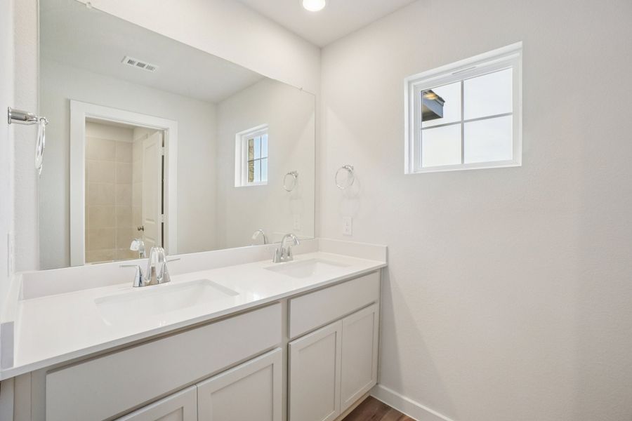 A bathroom with a large mirror.
