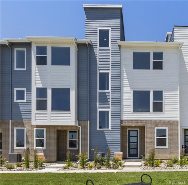 Front exterior of a new home in Dillon Pointe - Skyview, Broomfield, CO, highlighting curb appeal (Image 1).