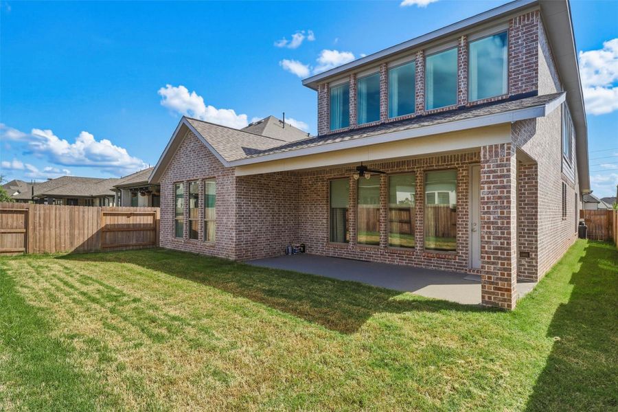 The backyard offers the perfect balance of open green space and covered outdoor living. Whether entertaining guests, letting pets roam, or simply enjoying a quiet evening outdoors, this space is ready to fit your lifestyle.