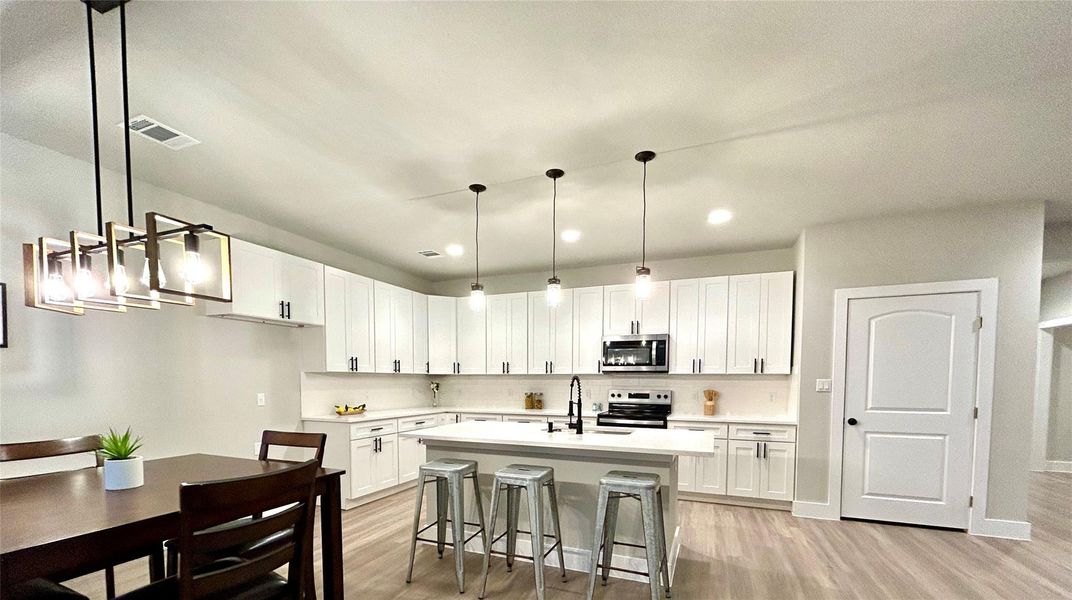 Kitchen with large pantry and extra seating at the kitchen island.