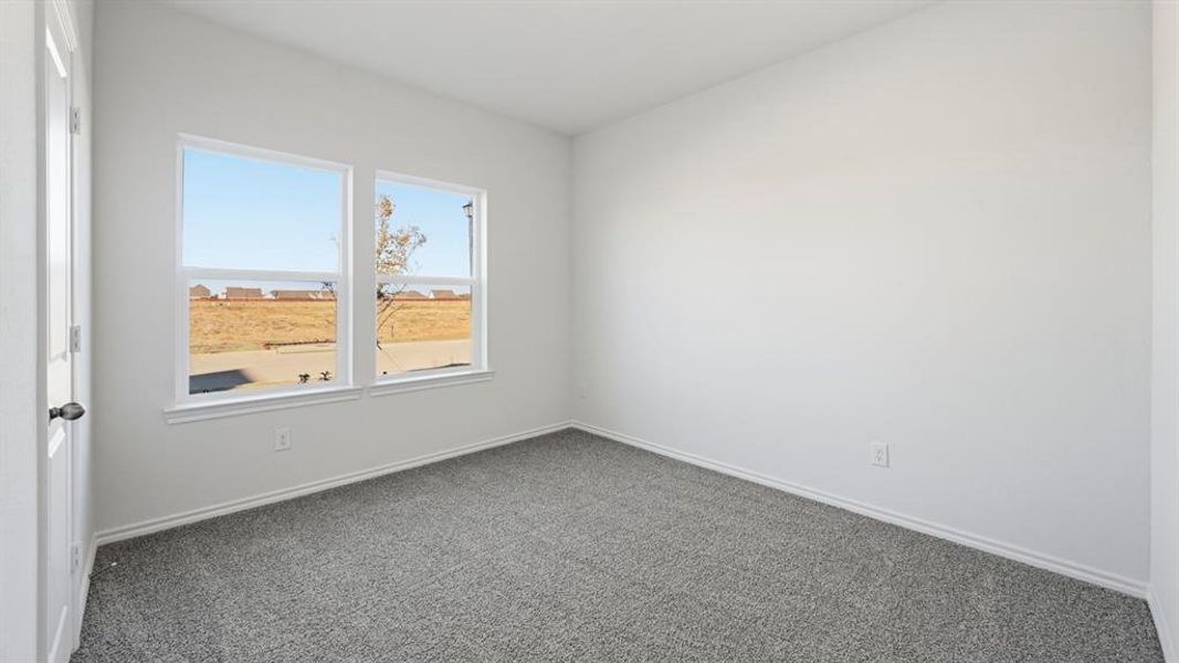 Carpeted empty room with baseboards