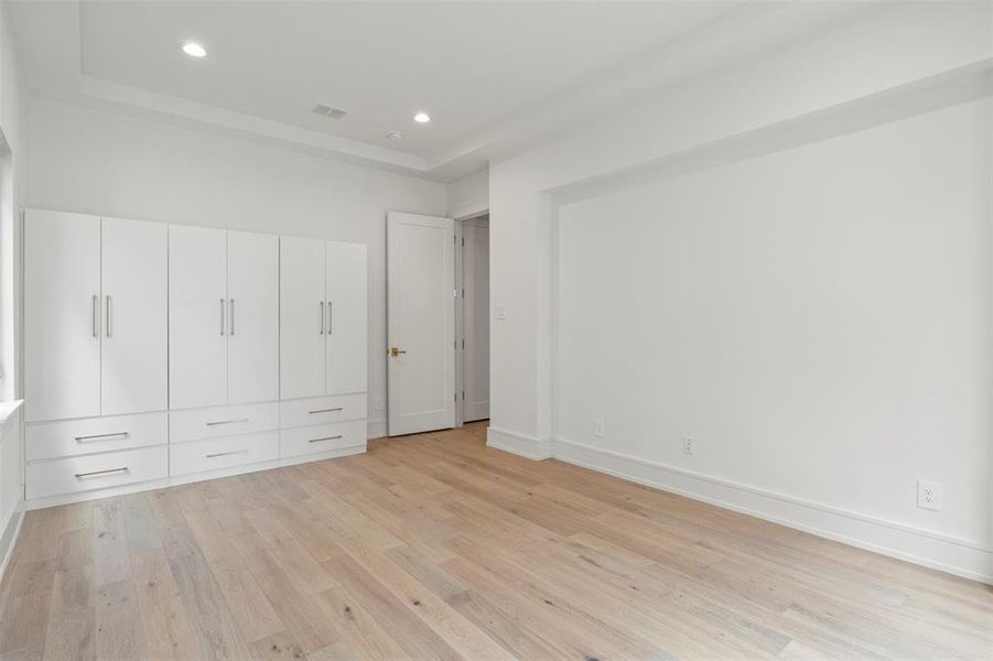 Unfurnished bedroom featuring light wood-style flooring and recessed lighting Unfurnished bedroom featuring light wood-style flooring and recessed lighting