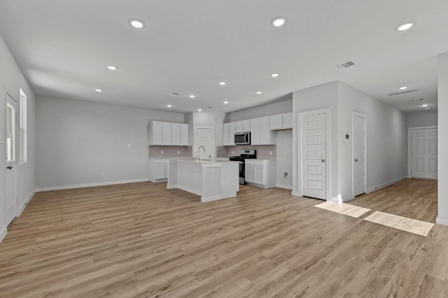 A large kitchen with white cabinets.