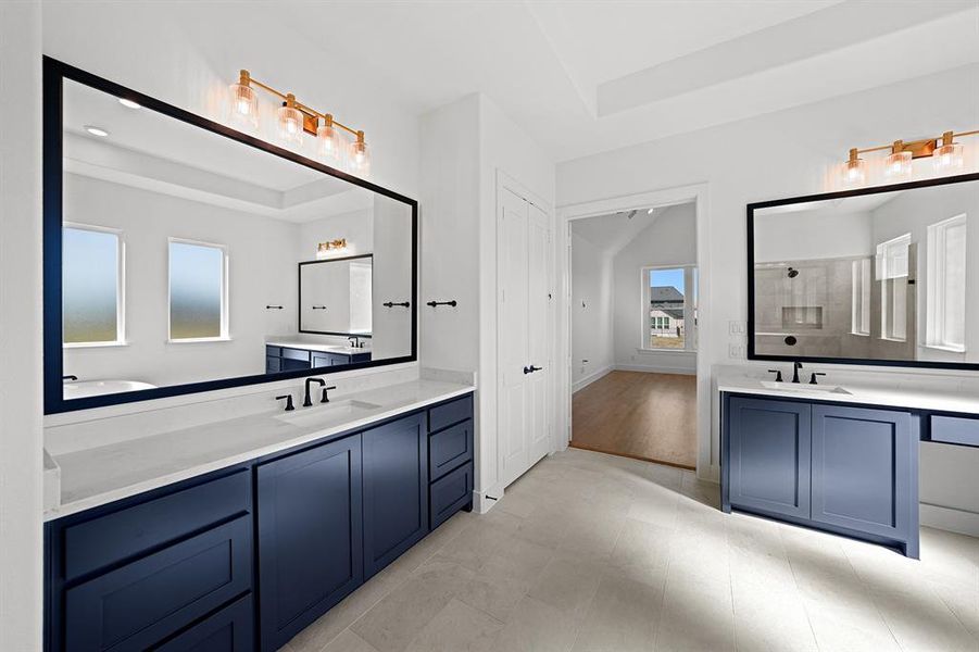 Full bathroom with two vanities, tiled shower, and a raised ceiling Full bathroom with two vanities, tiled shower, and a raised ceiling