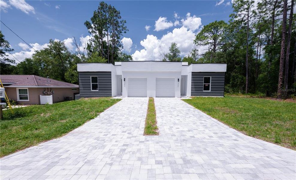 Front exterior of a new home in , Citrus Springs, FL, highlighting curb appeal (Image 1). Front exterior of a new home in , Citrus Springs, FL, highlighting curb appeal (Image 1).