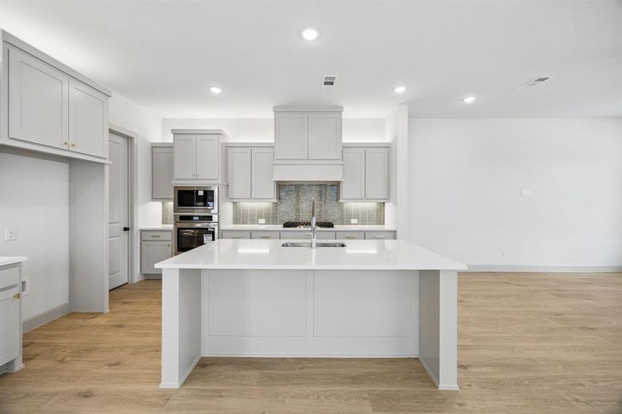 Your fantastic new kitchen features an oversized island perfect for friends and family to gather round!