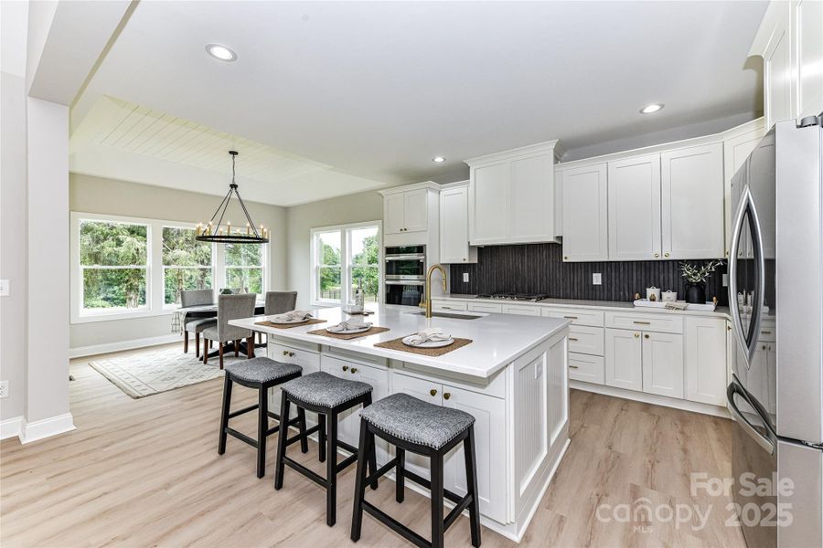 Upgrades throughout Kitchen including quartz counters, stainless steel appliances, gas cook top with vented hood, wall oven, spacious island with seating/storage, custom, tile back splash, plenty of cabinets for storage, dining area & pantry! Upgrades throughout Kitchen including quartz counters, stainless steel appliances, gas cook top with vented hood, wall oven, spacious island with seating/storage, custom, tile back splash, plenty of cabinets for storage, dining area & pantry!