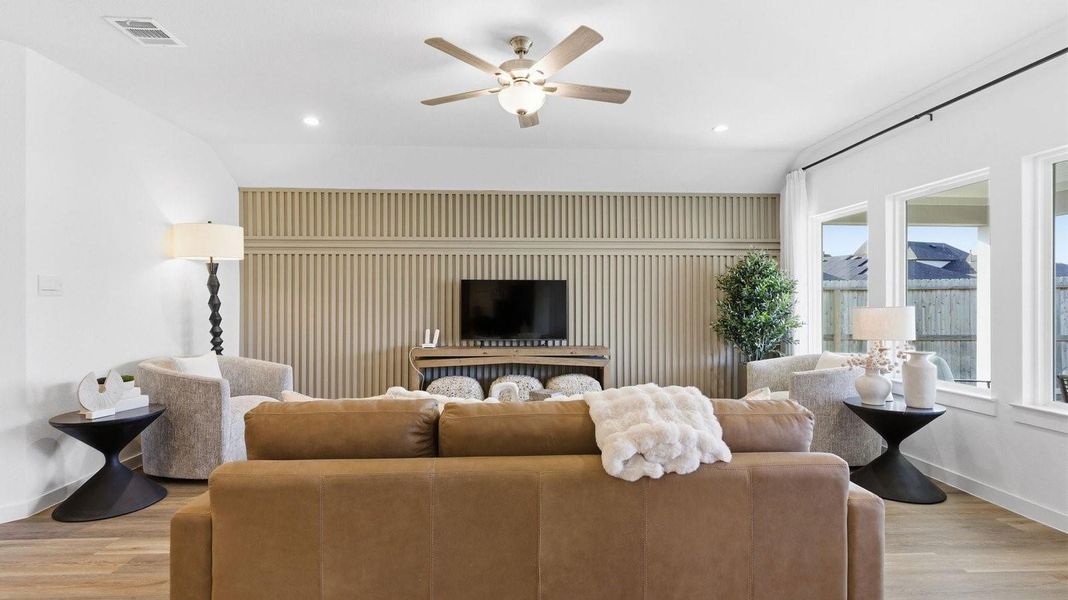 A well-organized living room that includes a kitchen and dining area, creating a warm and welcoming environment for gatherings. A well-organized living room that includes a kitchen and dining area, creating a warm and welcoming environment for gatherings.