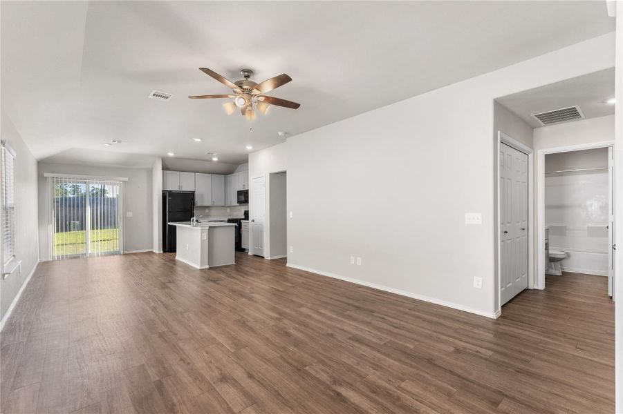 Kitchen with island and view of dining area featuring sliding glass door to backyard. Kitchen with island and view of dining area featuring sliding glass door to backyard.