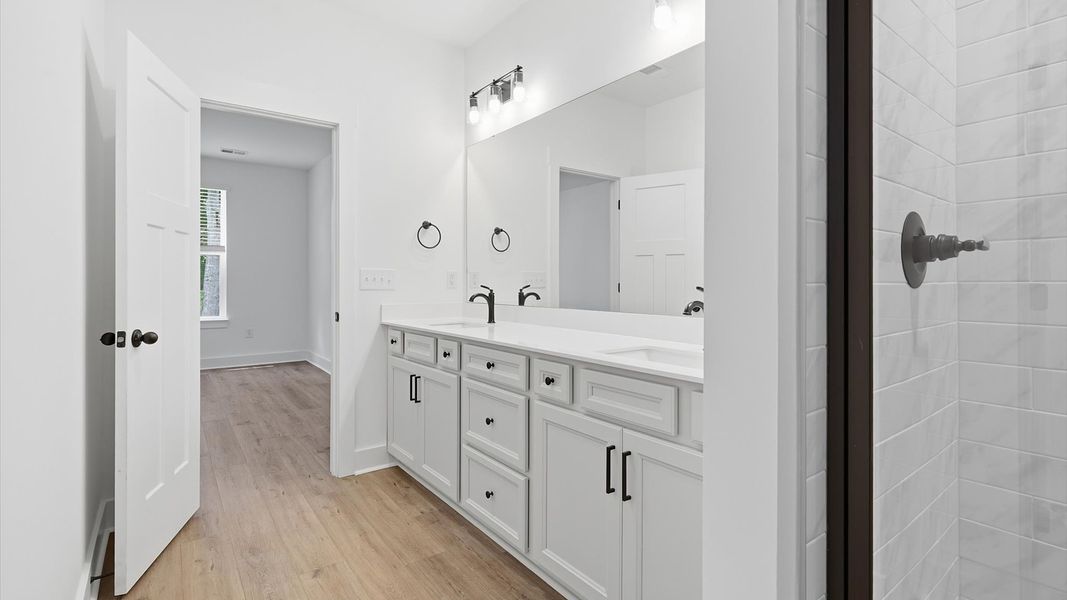Memorable mornings begin in this elegant primary bathroom with walk-in shower and double vanity in Anderson, SC Memorable mornings begin in this elegant primary bathroom with walk-in shower and double vanity in Anderson, SC