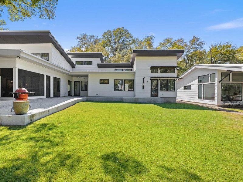 Back of house with a sunroom, a lawn, and a ceiling fan