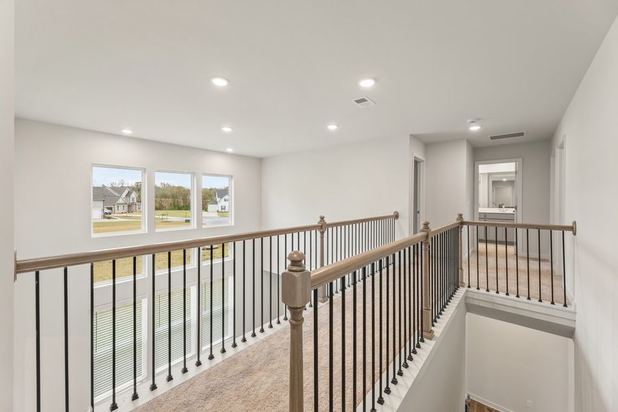 A large white room with a railing. A large white room with a railing.