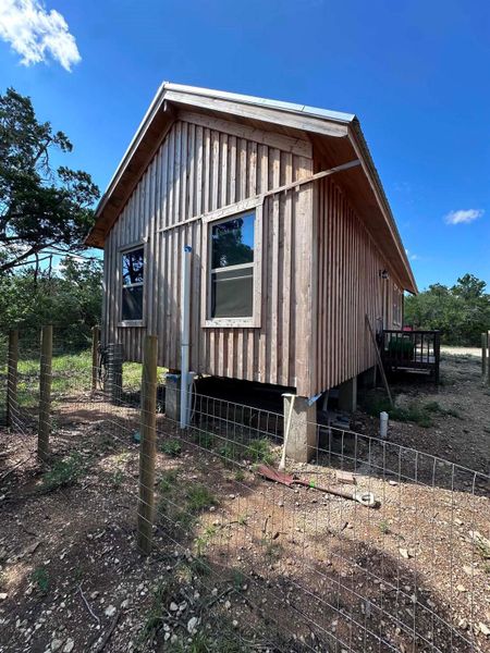 Board and batten siding covers this elevated rural retreat with rustic charm.