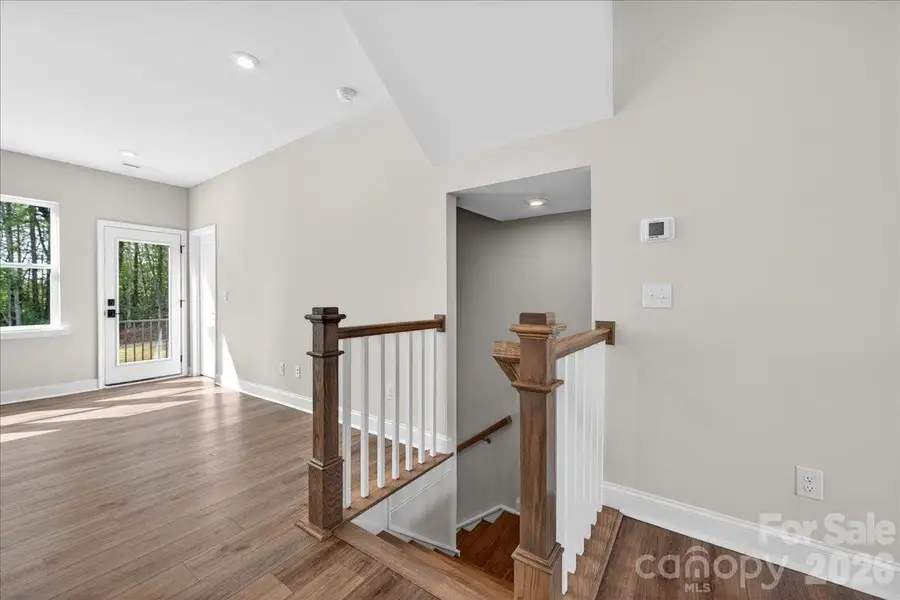 Second floor landing with open rail stairs