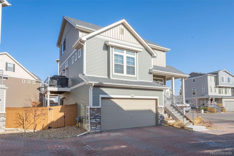 Front exterior of a new home in Reunion, Commerce City, CO, highlighting curb appeal (Image 2).