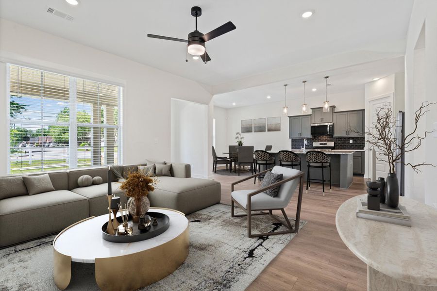 Open-concept living space featuring wood-finish flooring and recessed lighting