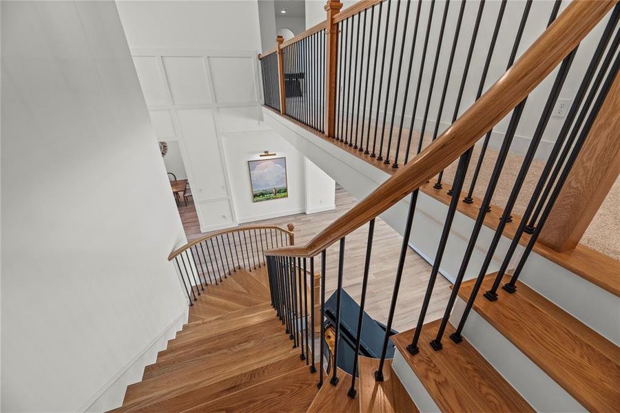 There is even beauty in the staircase. The touches of neutral colors and designer iron spindles compliment this space perfectly.