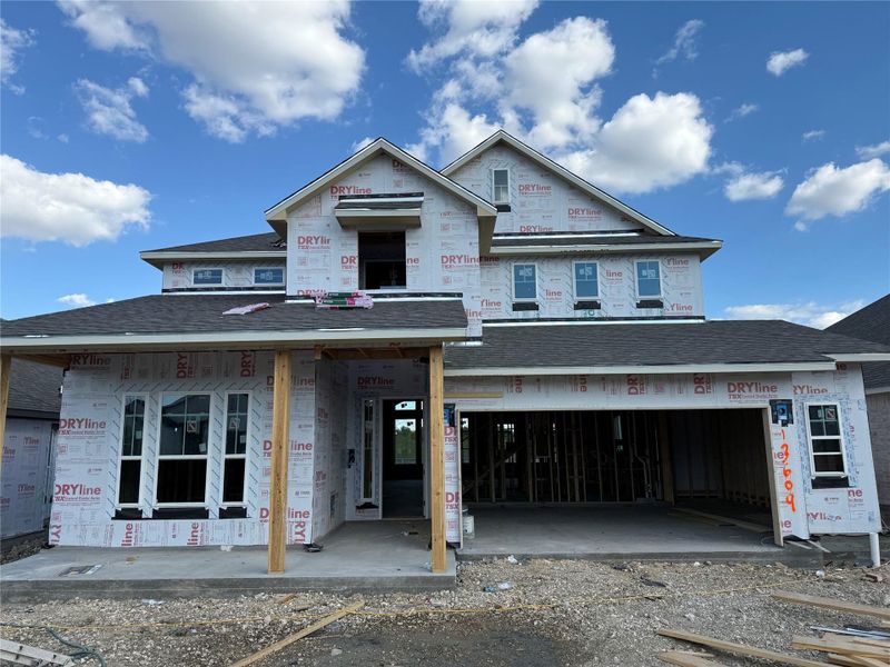 Property in mid-construction with a shingled roof and a garage Property in mid-construction with a shingled roof and a garage