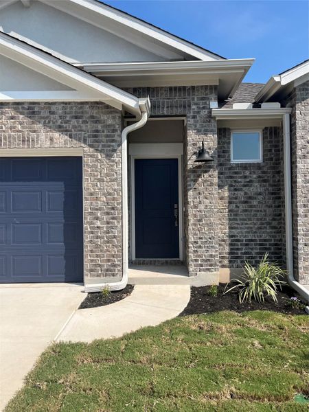 Front exterior of a new home in Anthem Cottages, Kyle, TX, highlighting curb appeal (Image 13).
