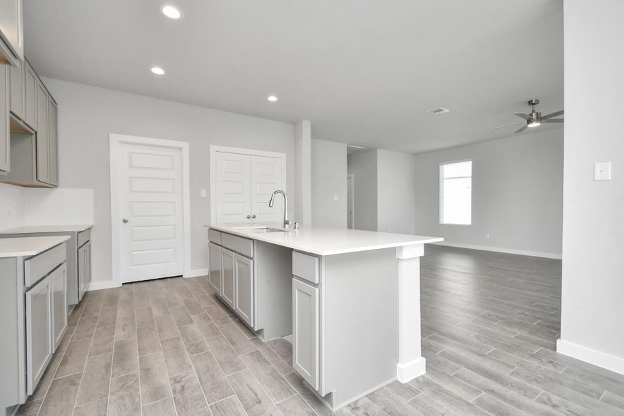 The open concept effortlessly connects the kitchen to the expansive family room, forming a perfect hub for gatherings. This seamless flow creates an inviting space where cooking and socializing come together harmoniously. Sample photo of completed home with similar floor plan. Actual colors and selections may vary.