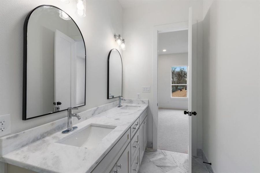 All bathrooms are elegantly appointed with marble countertops.