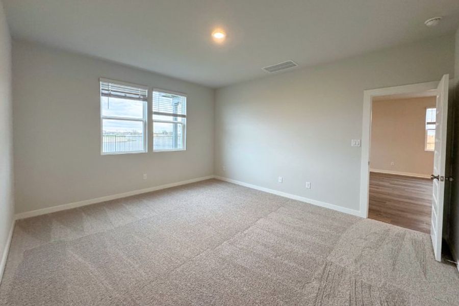 A room with a carpet and windows. A room with a carpet and windows.