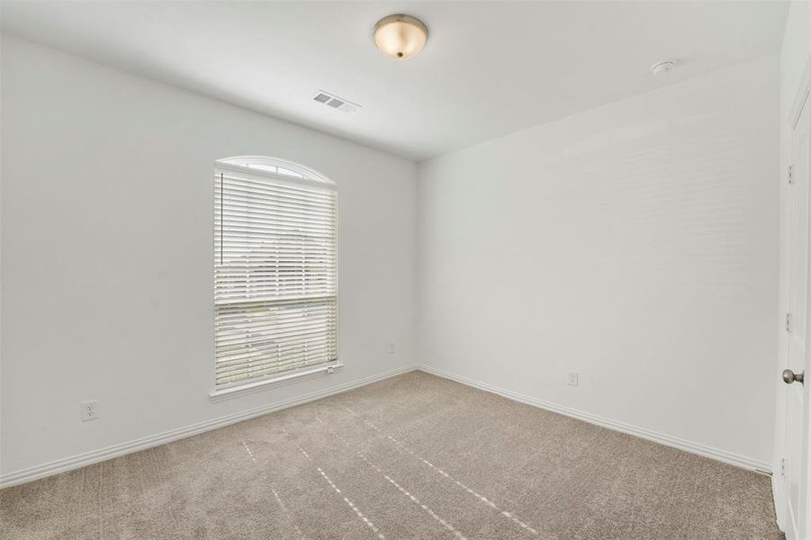 Empty room with light colored carpet