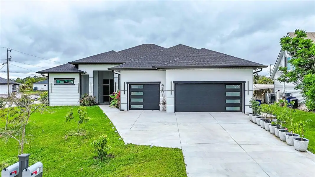 Front exterior of a new home in , Lehigh Acres, FL, highlighting curb appeal (Image 25).