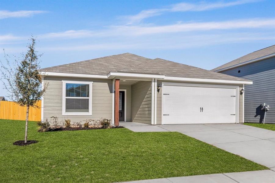 Ranch-style home featuring a front lawn and a garage