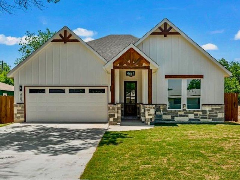 Modern inspired farmhouse with a garage, concrete driveway, roof with shingles, and a front yard