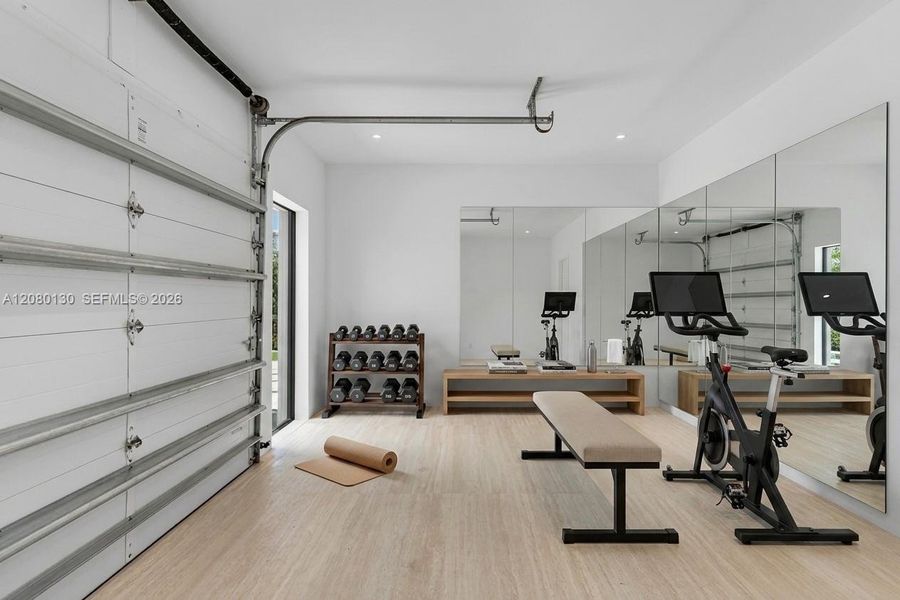 Garage/Gym. Disclaimer: Several photographs presented in this listing contain digitally added furniture, artwork, and decor. These virtually staged images are intended solely for illustrative purposes.