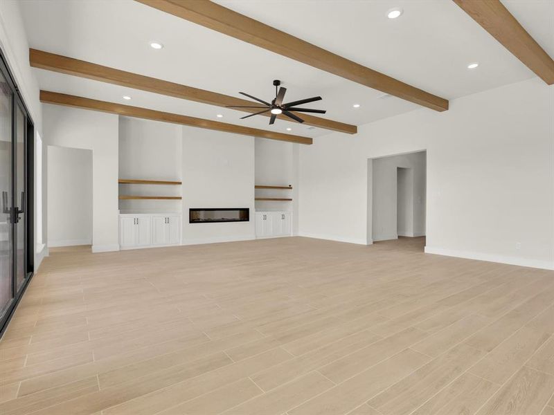 durable light wood look tile, electric fireplace and 15' ceilings