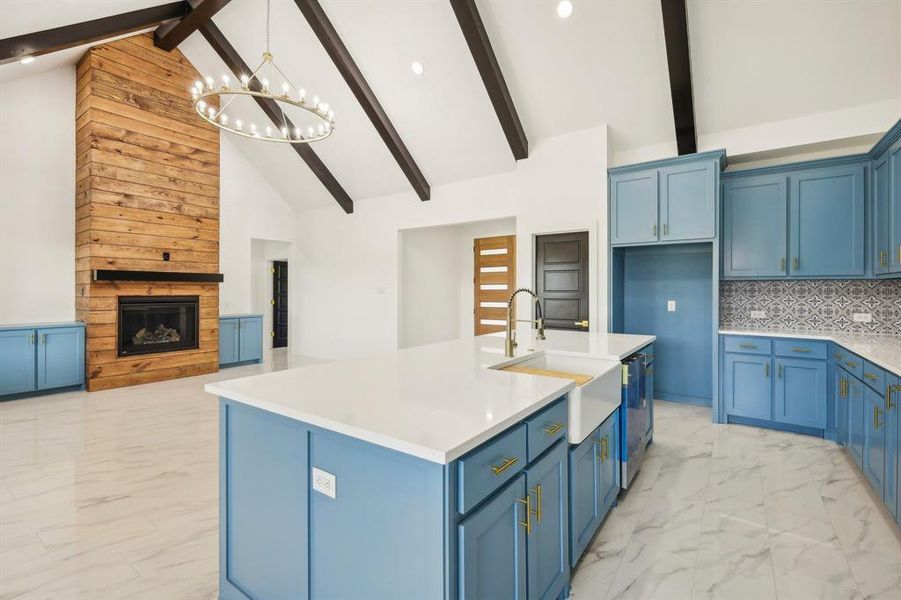 Kitchen featuring backsplash, sink, and blue cabinets