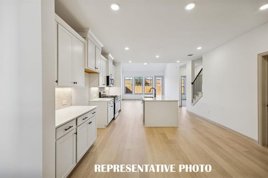 Featuring sight lines from the front through to the wall of windows across the rear of the home, our Farley floor plan offers the perfect place for you to welcome friends and family!  REPRESENTATIVE PHOTO