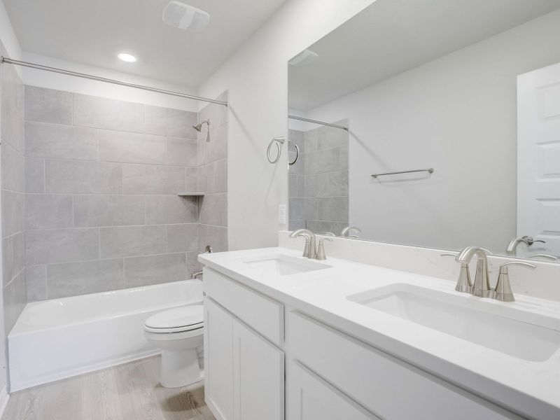 This guest bathroom with dual sinks makes getting ready easier for everyone.