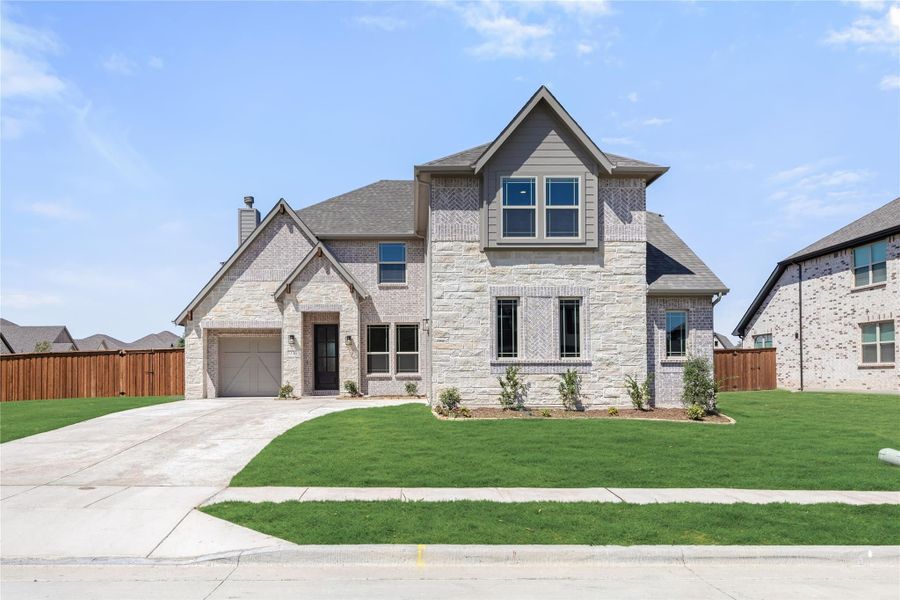 Two-story home with stone and brick exterior, single-car garage, and manicured front lawn Two-story home with stone and brick exterior, single-car garage, and manicured front lawn