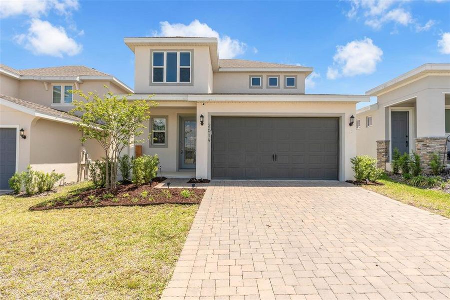 Front exterior of a new home in Hills of Minneola, Minneola, FL, highlighting curb appeal (Image 2). Front exterior of a new home in Hills of Minneola, Minneola, FL, highlighting curb appeal (Image 2).