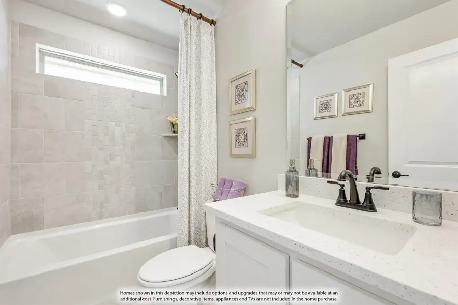 Bathroom with white vanity, quartz countertop, tiled tub-shower combo, and large mirror Bathroom with white vanity, quartz countertop, tiled tub-shower combo, and large mirror